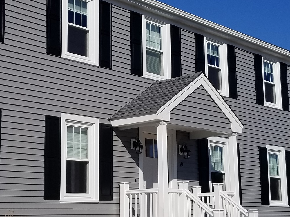 Front entry siding refresh with new porch railings and matching trim details