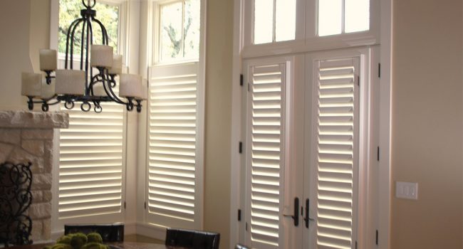 Tall replacement windows and patio doors finished with interior shutters